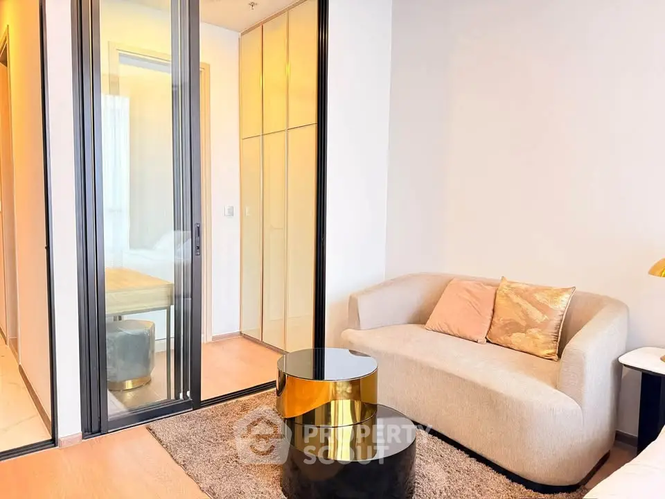 Modern living room with elegant sofa and stylish coffee tables in a cozy apartment setting.