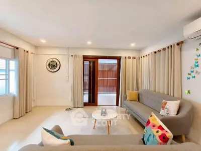 Charming living room with modern decor and cozy seating, perfect for relaxation and entertaining.