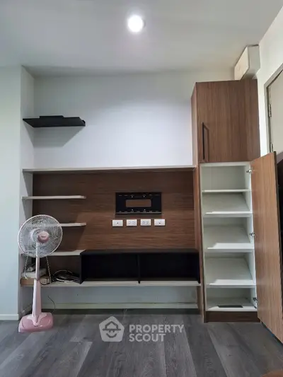 Modern living room with built-in wooden shelves and sleek design