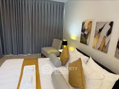 Luxurious bedroom with elegant decor and modern art, featuring plush bedding and ambient lighting.