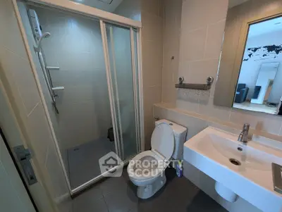 Modern bathroom with sleek shower and contemporary fixtures in a stylish apartment.