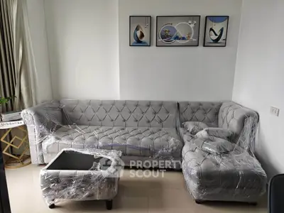 Elegant living room with plush gray sofa set and modern art decor