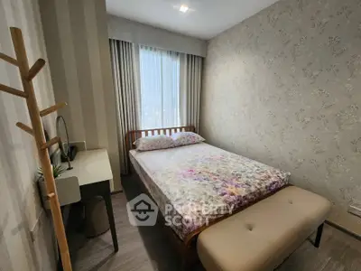 Cozy bedroom with floral bedding and elegant wallpaper, perfect for a restful retreat.
