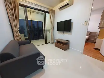 Modern living room with balcony access and sleek furnishings in a stylish apartment.