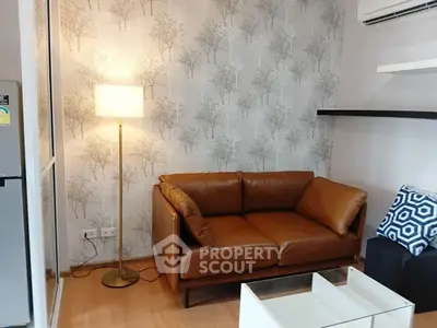 Cozy living room with leather sofa and stylish wallpaper