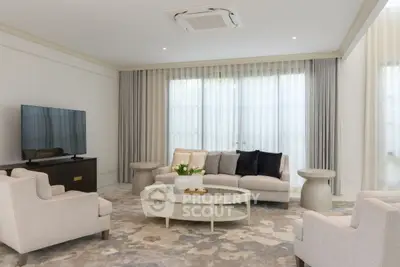 Elegant living room with modern furniture and large windows for natural light.