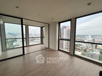 Spacious corner unit with panoramic city views and floor-to-ceiling windows.