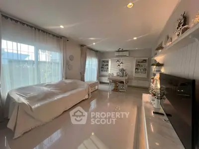 Spacious and elegant living room with modern decor and abundant natural light.