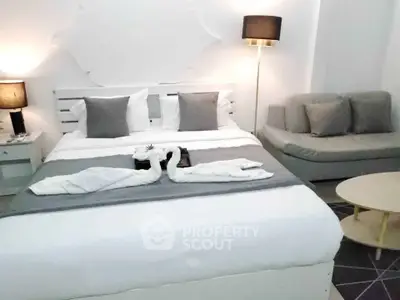 Elegant bedroom with stylish decor and cozy seating area