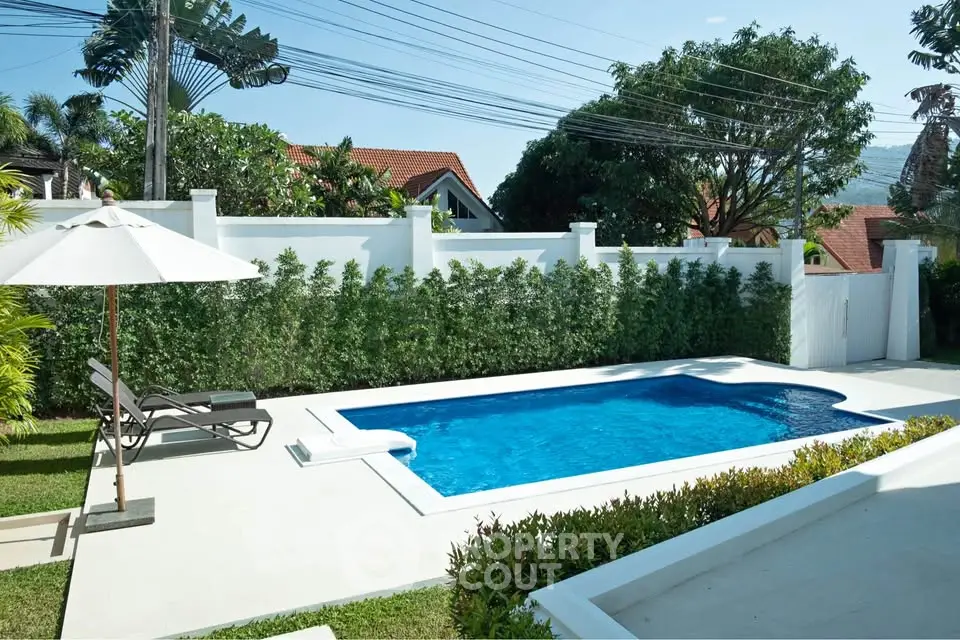 Luxurious private pool in a serene backyard setting with lush greenery and modern design.