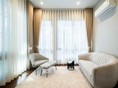 Elegant living room with modern furniture and large windows