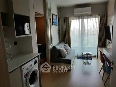 Modern living room with washing machine and balcony view
