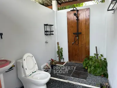 Charming outdoor bathroom with modern fixtures and natural decor elements.