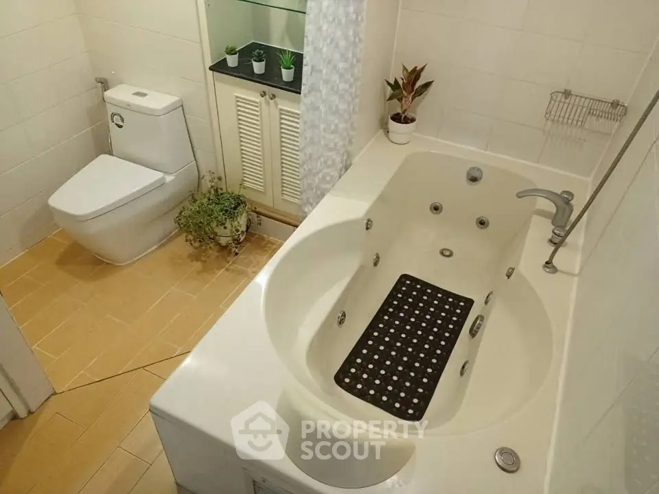 Modern bathroom with jacuzzi tub and sleek toilet design