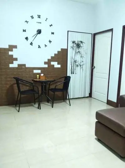 Cozy living room with unique wall clock and modern seating area.