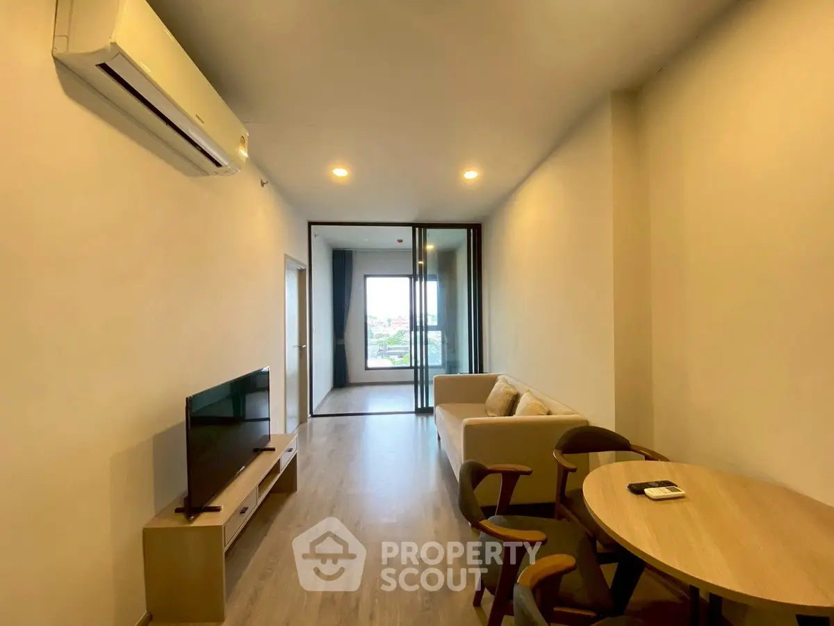 Modern living room with air conditioning and balcony view in a stylish apartment.