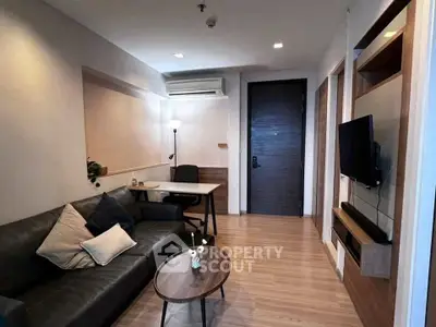 Modern living room with sleek furniture and wall-mounted TV, perfect for urban living.