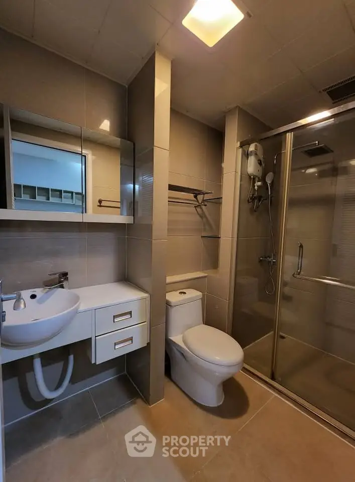 Modern bathroom with glass shower and sleek fixtures
