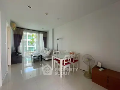 Spacious living room with modern furniture and natural light in a stylish apartment.