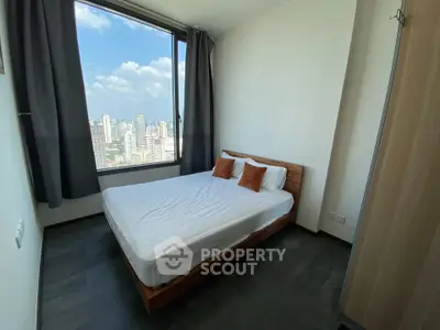 Modern bedroom with stunning city view from large window, featuring cozy bed and minimalist decor.