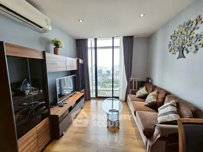 Modern living room with city view, stylish furniture, and elegant decor in a high-rise apartment.