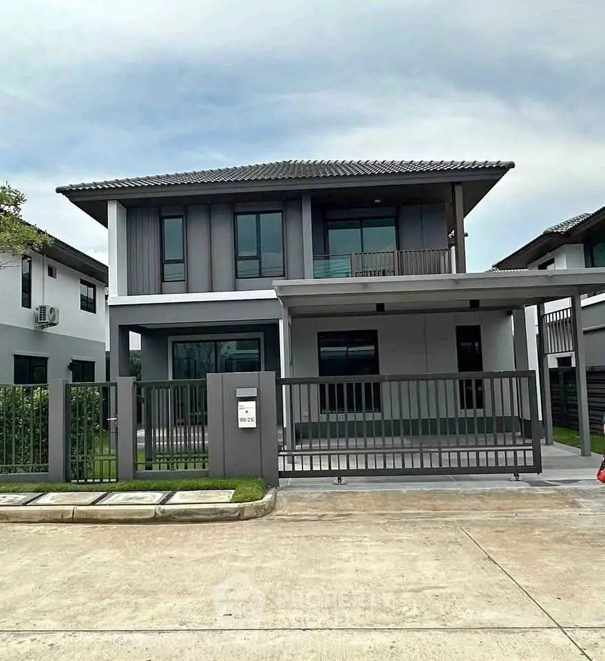 Modern two-story house with sleek design and spacious driveway in a serene neighborhood.