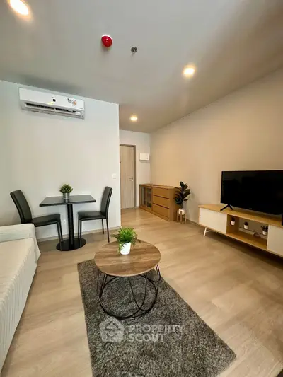 Modern living room with stylish furniture and air conditioning, perfect for comfortable living.