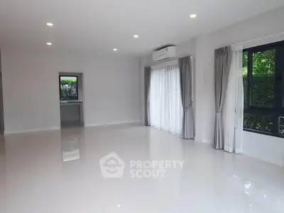 Spacious living room with large windows and natural light