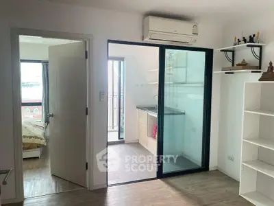 Modern apartment with open layout, featuring a bedroom, balcony, and air conditioning.