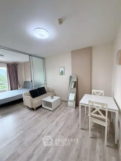 Modern studio apartment with open layout, featuring a cozy living area and stylish decor.