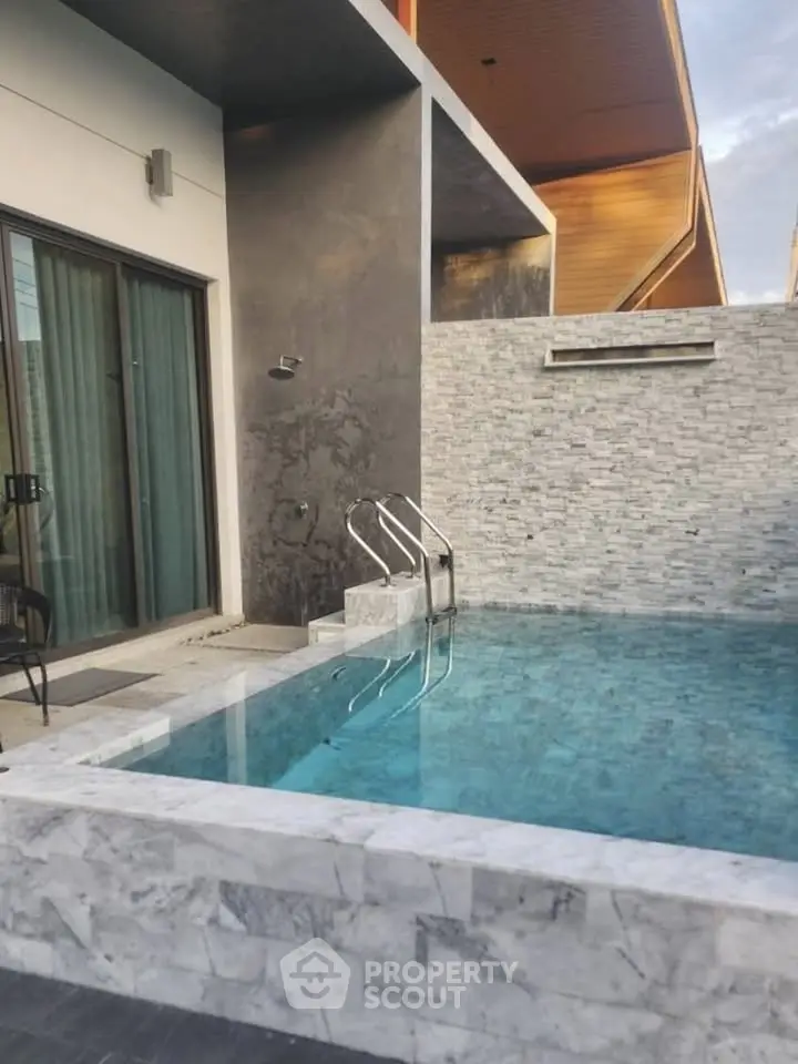 Luxurious modern pool area with sleek design and elegant stonework, perfect for relaxation and entertainment.