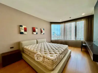 Spacious bedroom with city view, modern decor, and large windows in luxury apartment.