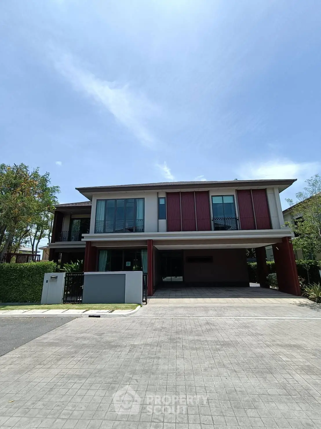 Modern two-story house with spacious driveway and contemporary design.
