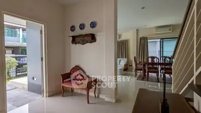 Elegant interior with vintage furniture and open layout, showcasing a cozy living and dining area.