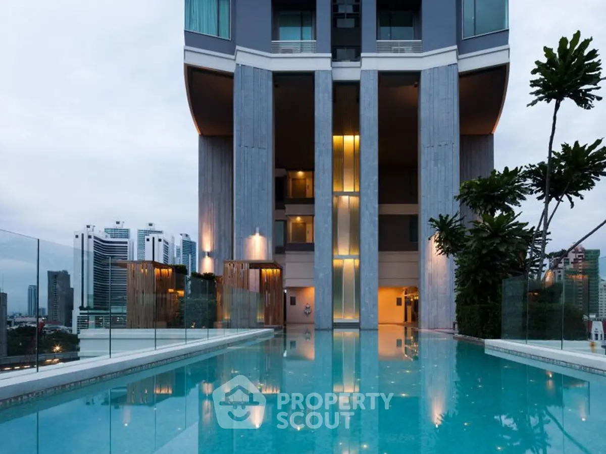 Luxurious high-rise building with stunning rooftop pool and city skyline view.