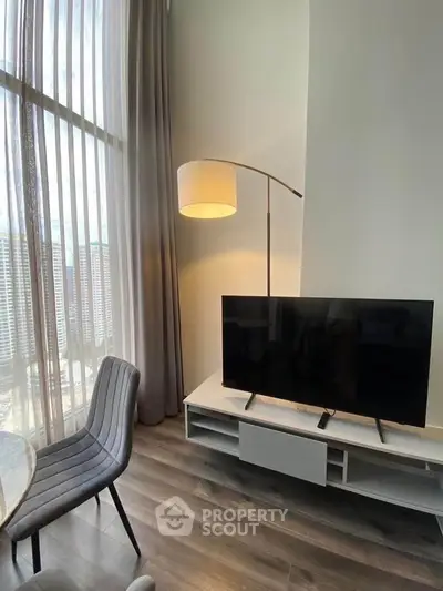 Modern living room with floor-to-ceiling windows and sleek furniture