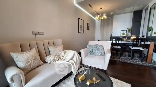 Elegant living room with cozy seating and modern dining area in open layout apartment.