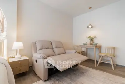 Cozy living room with recliner sofa and dining area, perfect for relaxation and entertaining.