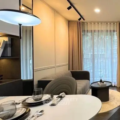 Stylish modern living room with elegant decor and large window view.