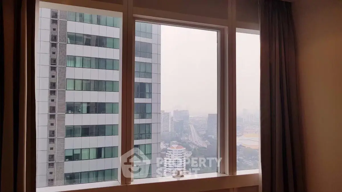 Stunning cityscape view from a modern high-rise apartment window, showcasing urban living at its finest.