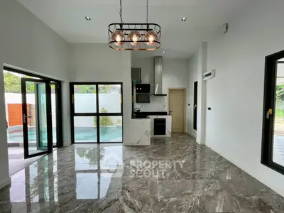 Modern open-plan living room with elegant marble flooring and stylish lighting