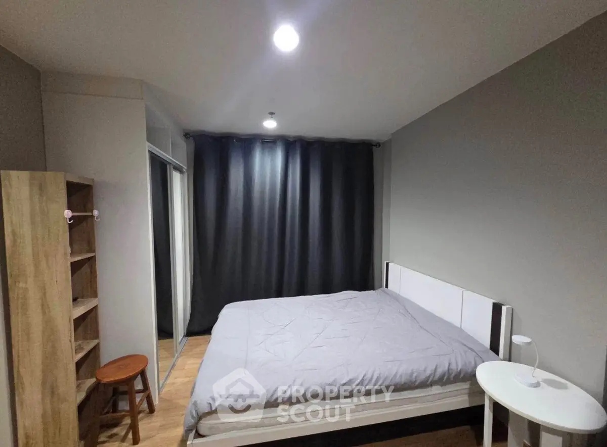 Cozy modern bedroom with minimalist decor and soft lighting.