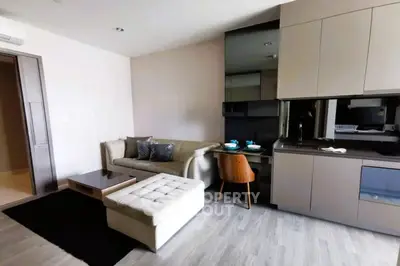 Modern living room with stylish furniture and sleek kitchen area