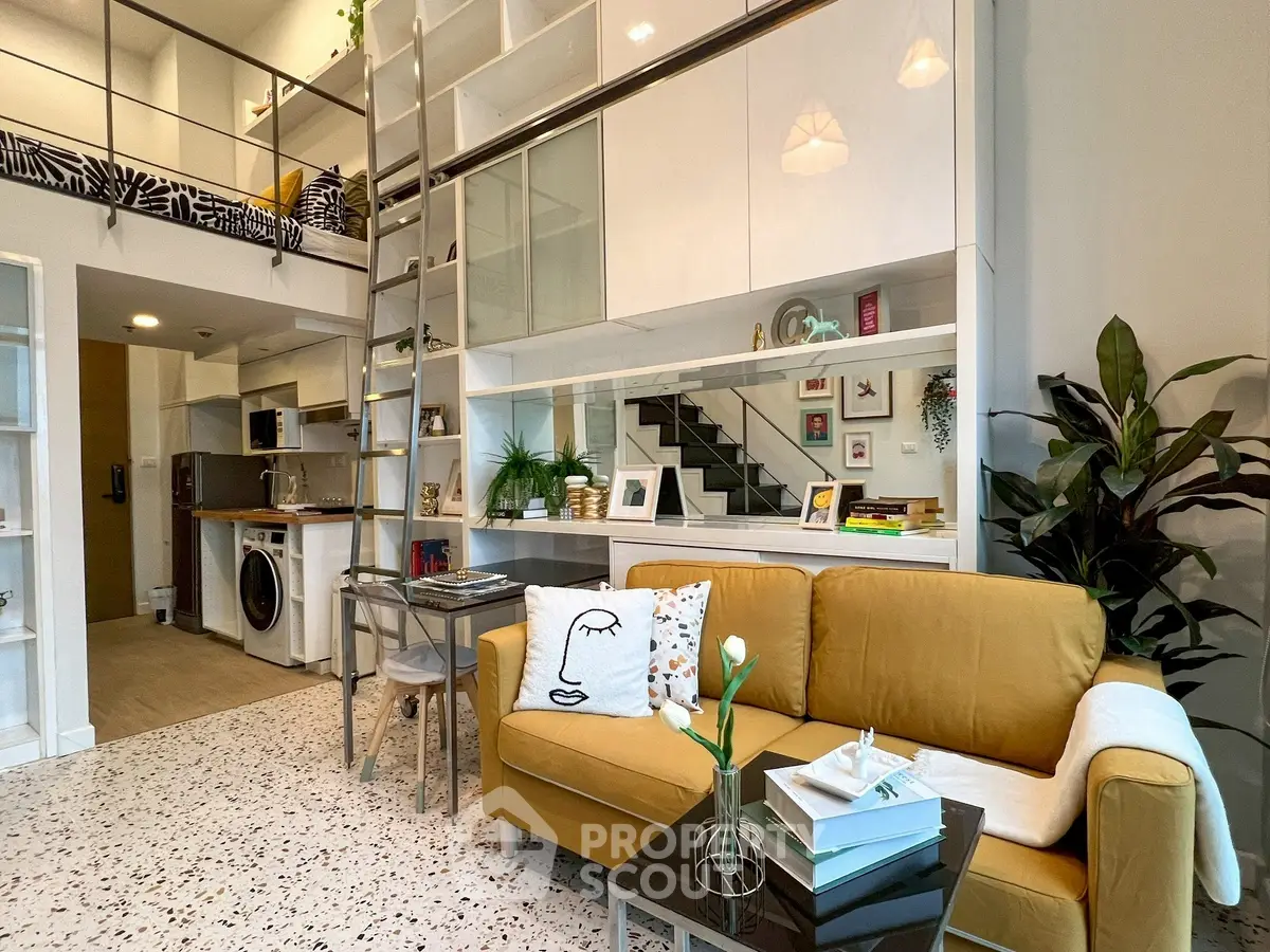 Stylish modern living room with loft, yellow sofa, and open kitchen layout.