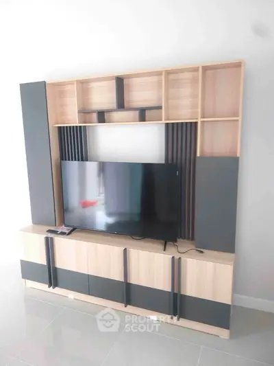 Modern living room with sleek TV unit and ample storage space