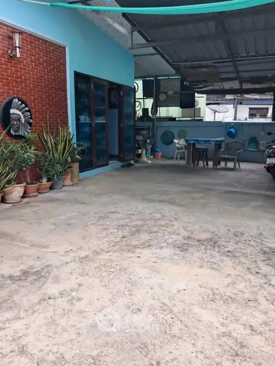 Spacious outdoor patio with seating area and decorative plants