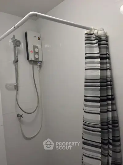Modern bathroom shower with striped curtain and water heater