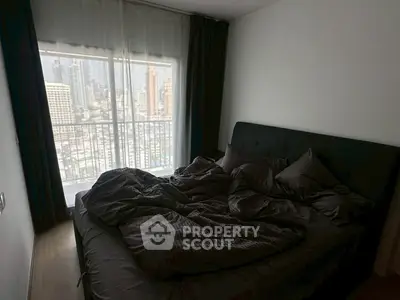 Cozy bedroom with city view and modern decor in urban apartment