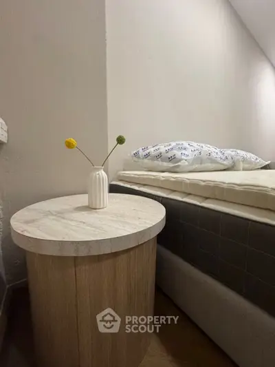 Cozy bedroom corner with modern side table and minimalist decor