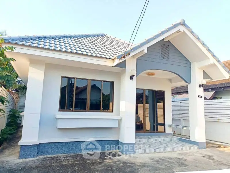 Charming single-story house with tiled roof and spacious front entrance in a serene neighborhood.